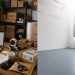 Busy packing workspace contrasted with empty room.